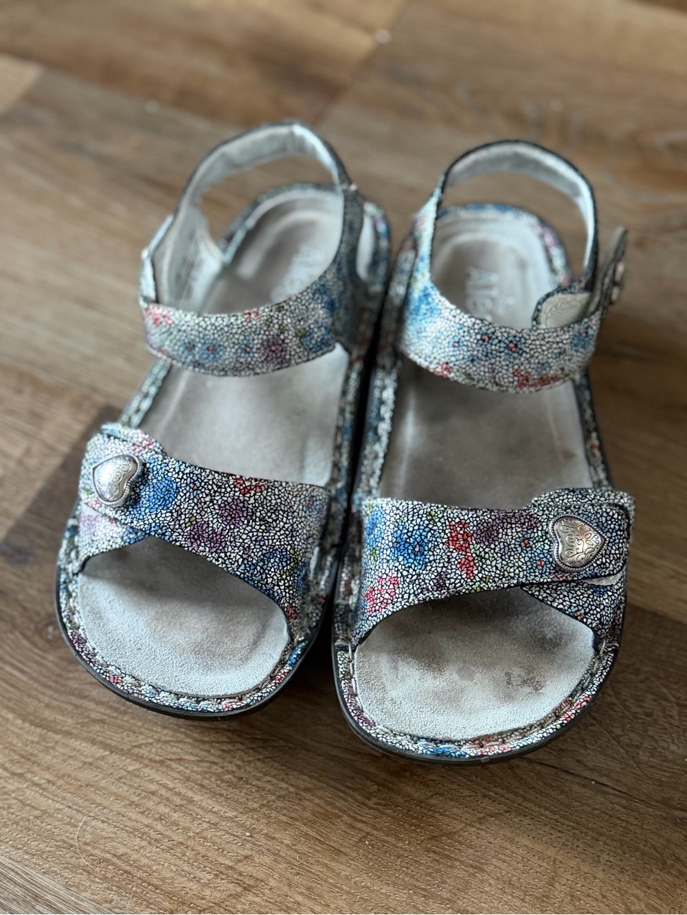 Alegria women’s metallic Multi-Color Heart Buckle Sandals